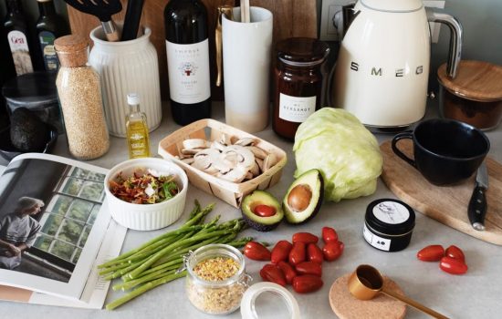 A variety of fresh ingredients and kitchen tools for preparing a healthy meal.